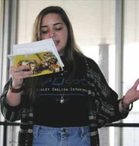 Junior English major Lydia Strubhar performs a sample of her work Tuesday at the Broadside open mic in Lydia’s Lounge. Photo by Maggie Cipriano.