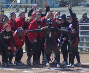 Senior Lexi Cremeens is greeted at home plate by the Bradley softball team after her home run Saturday. Photo by Dan Smith.