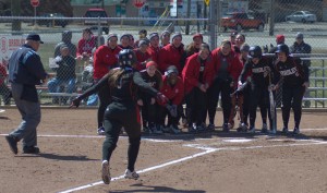 The Bradley softball team gathers at home plate to celebrate Lexi Cremeens’ (9) home run in a game against Loyola-Chicago last month. The Braves finish the regular season against Evansville this weekend. Photo from Scout Archives.