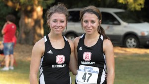 Caitlin and Kristen Busch pose together after a cross country race. Photo via bradleybraves.com.