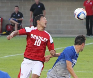 Senior midfielder Alex Garcia plays a ball over a Houston Baptist player during the Braves 1-0 win over the Cougars on Aug. 30. Photo by Adam Rubinberg.