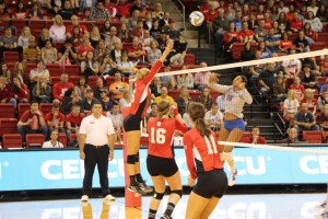 Sophomore Jamie Livudais rises up for a block against a DePaul player in a 3-0 loss to Depaul University. Photo by Ann Schnabel.