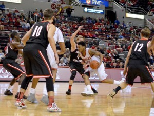 Antoine Pittman (center) drives against an Edgewood defender. Pittman and the Braves shot 45 percent from the field against Edgewood. Photo by Moira Nolan.
