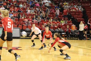 Jessica Teel (right) digs a ball in front of Lea Sack (Left) and Kayla Rymer. Photo by Adam Rubinberg.