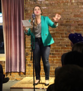 A student reads her poetry at the Writehouse Ink open mic night Thurs- day, which was held at One World Café. Photo by Ann Schnabel.