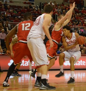 Bradley guard Ronnie Suggs (center) drives to the hoop in a game against Ball St., No. 13. Suggs is averaging 5.8 points per game. Photo by Moira Nolan.
