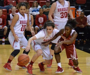 Guard Kat Yelle (center) fights off an Oklahoma defender for a loose ball. The Braves recorded 19 turnovers in the game against the No. 17 Sooners, as they lost 79-46. Photo by Anna Foley.