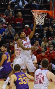 Freshman guard Antoine Pittman (center) glides to the basket for a layup over Northern Iowa guard Wyatt Lohaus (33). Pittman was sec- ond on the Braves in scoring with 14 points and hit four threes. Photo by Anna Foley.