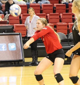 Lea Sack (front) hits the ball while head coach Jenny Maurer (back) looks on. Sack said she was surprised at Maurer’s resignation earlier this month, but that it also made sense. Photo by Anna Foley.