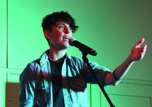 Slam poet Andrea Gibson performs in Michel Student Center Ballroom last night for an event hosted by Common Ground, the LGBTQ+ group on campus. Photo by Ann Schnabel.