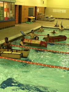 Members of SHPE and SHPE Jr. set up the cardboard canoes they created in the Manual High School pool. Photo by Maddie Gehling.