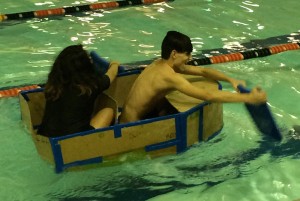 Society of Hispanic Professional Engineers (SHPE) Jr. members from the Manual High School chapter race their cardboard boat across the gym- nasium pool. Photo by Maddie Gehling.