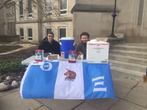 Members of Theta Xi hand out cups of coffee in front of Bradley Hall Wednesday to support Three Avocados, a non-profit coffee company. Photo by Michael Echeverri.
