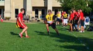 Member of faculty Marshall Escue attempt to juke senior Brock Fuhrmann in the Bradley Bowl. Photo by Eytan Herman.