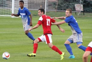 Sophomore forward Frank Bak dribbles past an opposing defender in a match last season. Photo by Anna Foley.