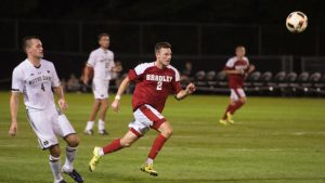 Braves junior forward Richard Olson splits two Fairleigh Dickinson defenders and scored the game-winning goal against Notre Dame Sept. 2. Photo via bradleybraves.com.