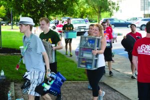 Students involved in greek life help freshmen and their families move onto Bradley's campus during Welcome Week. Photo by Duane Zehr.