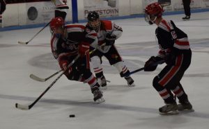 Sophomore Nicholas Marselle and freshman Kallin Wilson work together to keep the puck away from an Illinois State forward in Bradley's homecoming victory. Photo by Shelby Caruso.