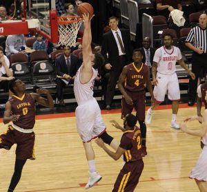 Sophomore Callum Barker, who models his style of play from Aron Baynes, rises for a dunk in a game last year. photo via Scout Archives