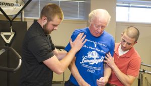 Dave Driscoll, who donated $10,000 to Bradley’s Physical Therapy Clinic, receives one-on-one care from Bradley students. photo via Bradley University Marketing