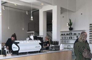 An employee at Zion Coffee Bar works behind the counter at the new shop, which opened Feb. 3 at 803 SW Adams St. in the Peoria Warehouse District. photo by Tori Moses