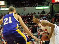 Junior Chris Roberts scans the court for an open man during Tuesday night’s game against first place Northern Iowa. The Braves led for most of the game but gave up five 3-point shots in the final minutes and eventually lost 61-58. Photo by Megan Loos