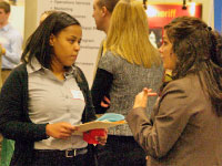 A student networks at Wednesday’s Spring Job and Internship Fair. Some employers who attended the fair have delayed hiring because of uncertain futures within their companies. Photo by Megan Loos