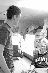 Resident adviser Danny Byrne speaks to freshman civil engineering major Neil Offerman in the dorms. Res Life staff undergo training to learn how to deal with issues on their floors. Photo by Megan Loos