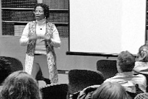 English professor reads one of her poems about the disappearing women of Juarez, Mexico. Worley wrote the poems to give voice to the 5,400 women who have disappeared or have been murdered. Photo by Louis Amberg