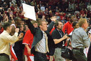 Fans rush the court after junior Chris Roberts makes a 75-foot bank shot at the buzzer of Monday night’s game against Oakland. The Braves defeated the Grizzlies 76-75, and eventually earned a trip to the inaugural CollegeInsider.com Postseason Tournament’s finale. Photo by Megan Loos