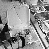 Freshman public relations major Regi Mele uses a Styrofoam to-go container to carry food out of the cafeteria. Students may see Styrofoam disappear in an attempt to become more eco-friendly.