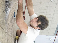 Sophomore medical science major Andrew Stewart climbs the 46-foot climbing wall in the Markin Center.