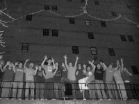 Students living on the seventh floor of Geisert Hall celebrate after hanging lights on the outside of their building. The task turned out to be more difficult than they expected, taking almost 10 hours and involving 15 students. Photo by Adam Moulton