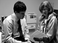 Junior nursing major Ben Henry discusses the H1N1 vaccine with a nurse in the Health Center in November. Henry was among the first students to receive the shot because he works around sick patients in hospitals for class. Photo by Adam Moulton