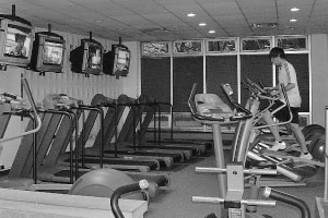 A lone exerciser works out in the Heitz Hall workout room. The university will close the room at the end of this school year. Administrators are not sure how the room will be used in the fall. Photo by Nafia Khan