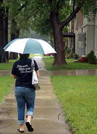 Junior public relations major Shayna Jensky tries to stay dry during the rain throughout the weekend. Photo By Megan Loos