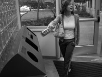 Sophomore advertising major Caitlyn Moore recycles a bottle in one of the recycling bins on campus. Photo by Megan Loos