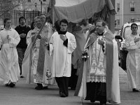 Monsignor Stanley Deptula leads a procession of the Eucharist from St. Mark’s Catholic Church to Olin Quad Saturday evening. The event was the second day of events during Holy Week, which leads up to Easter Sunday, the holiest day on the Christian calendar. Photo by Adam Moulton