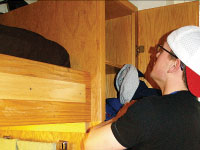 Freshman Tyler Hall removes clothes from his cabinet where mold was growing. In addition to the mold found in University Hall, bedbugs were found in several rooms in Geisert Hall. Photo by Megan Loos