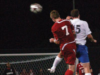 Sophomore Bryan Gaul sends a header toward the net in last Friday’s Game. Photo by Megan Loos