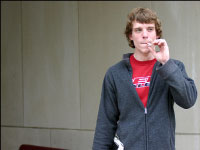 Senior journalism major Ryan Richards smokes a cigarette on campus this week. Senate is debating Monday over whether or not to change smoking rules on campus rules on campus. Photo by Latonya Reed