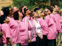 Participants in the living pink ribbon look up at a camera Thursday afternoon. A Peoria Fire Department ladder truck was used to get the aerial shot, which will be used to promote Race for the Cure. Students still interested in joining Team Bradley at Race for the Cure can sign up by visiting bradley.edu/jointeambradley. Photo by Megan Loos