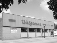 The abandoned Walgreens store at the intersection of Main Street and Bourland Avenue is the site a condominium developer is aiming to build two several story buildings on. The buildings will feature several amenities, including a pool and retail stores on the first level. Construction is expected to start in October. Photo by Megan Loos